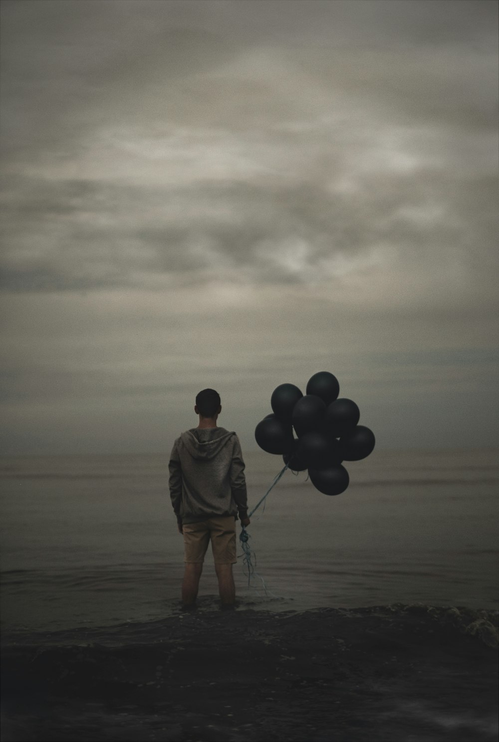 man holding balloons