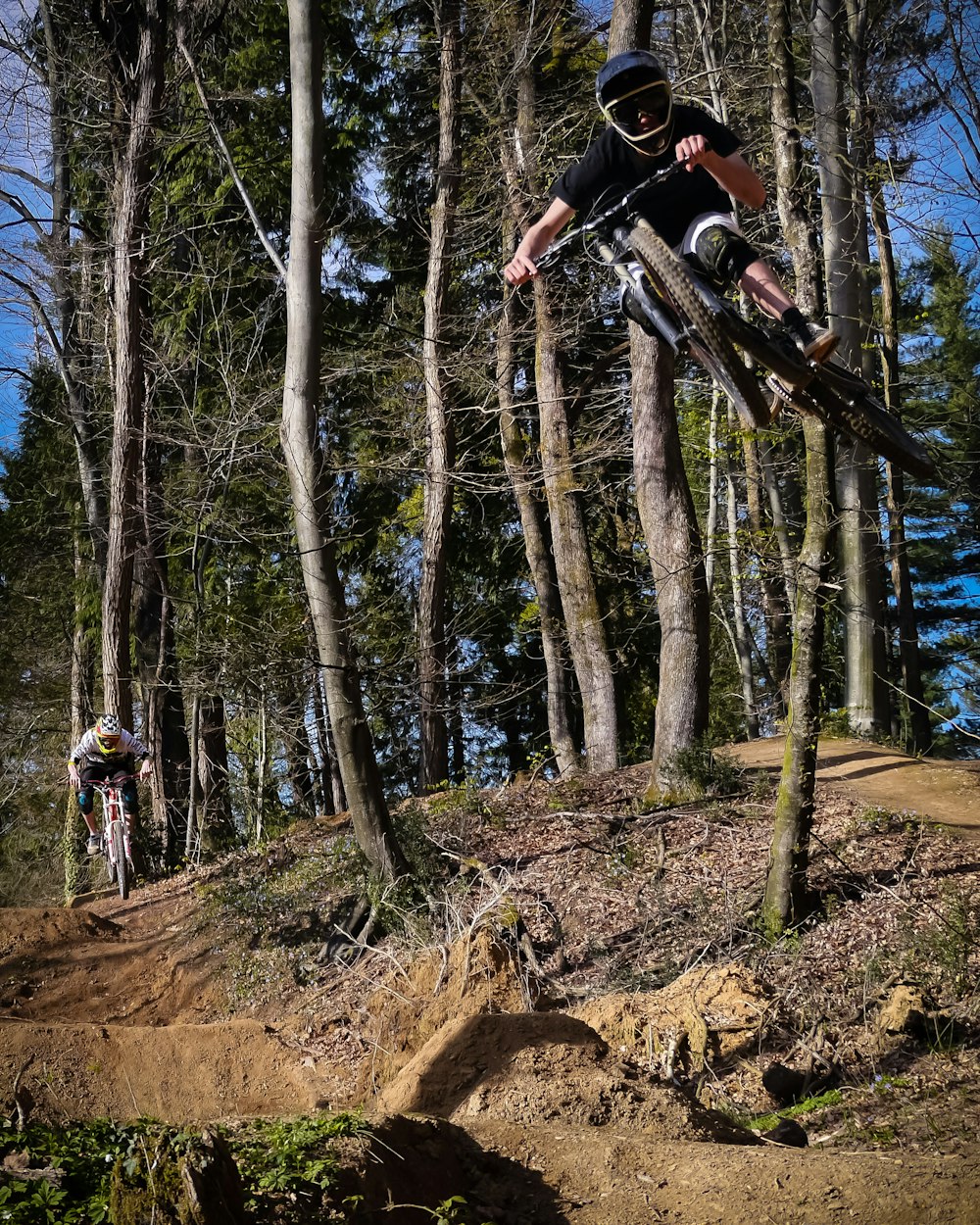 man riding on black downhill bike