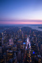 A sleek aerial view of Kuala Lumpur's skyline at dusk with soft neutral tones.