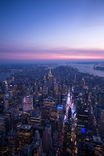 An aerial shot of a vibrant city skyline at dusk.
