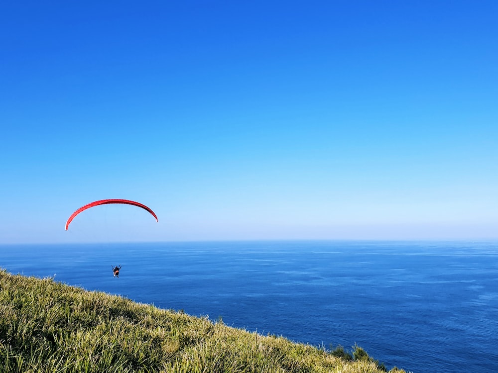 person parasailing on seashore