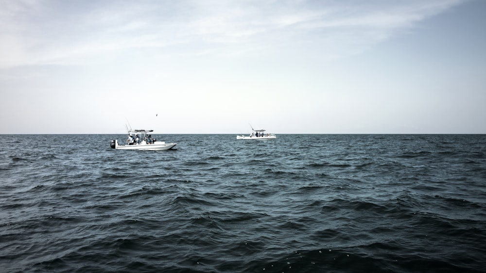 two white motor boats on sea during daytime