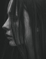 grayscale photo of woman's left side face covered with hair