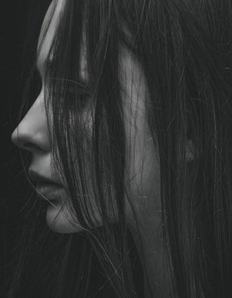 grayscale photo of woman's left side face covered with hair