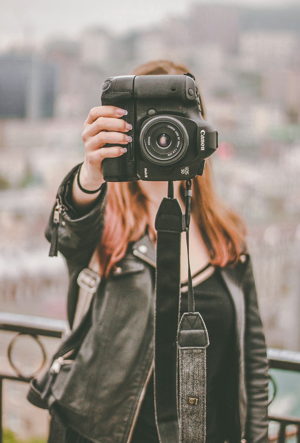 woman in black leather jacket holding black Canon DSLR camera photo – Free  Person Image on Unsplash