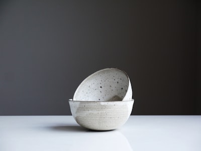 two white ceramic bowls ceramic teams background