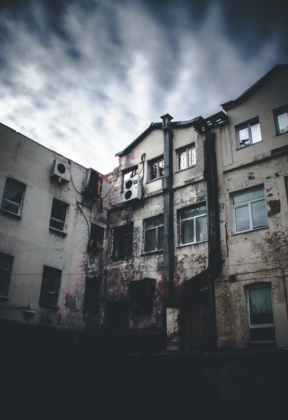 low angle photo of gray concrete building during daytime