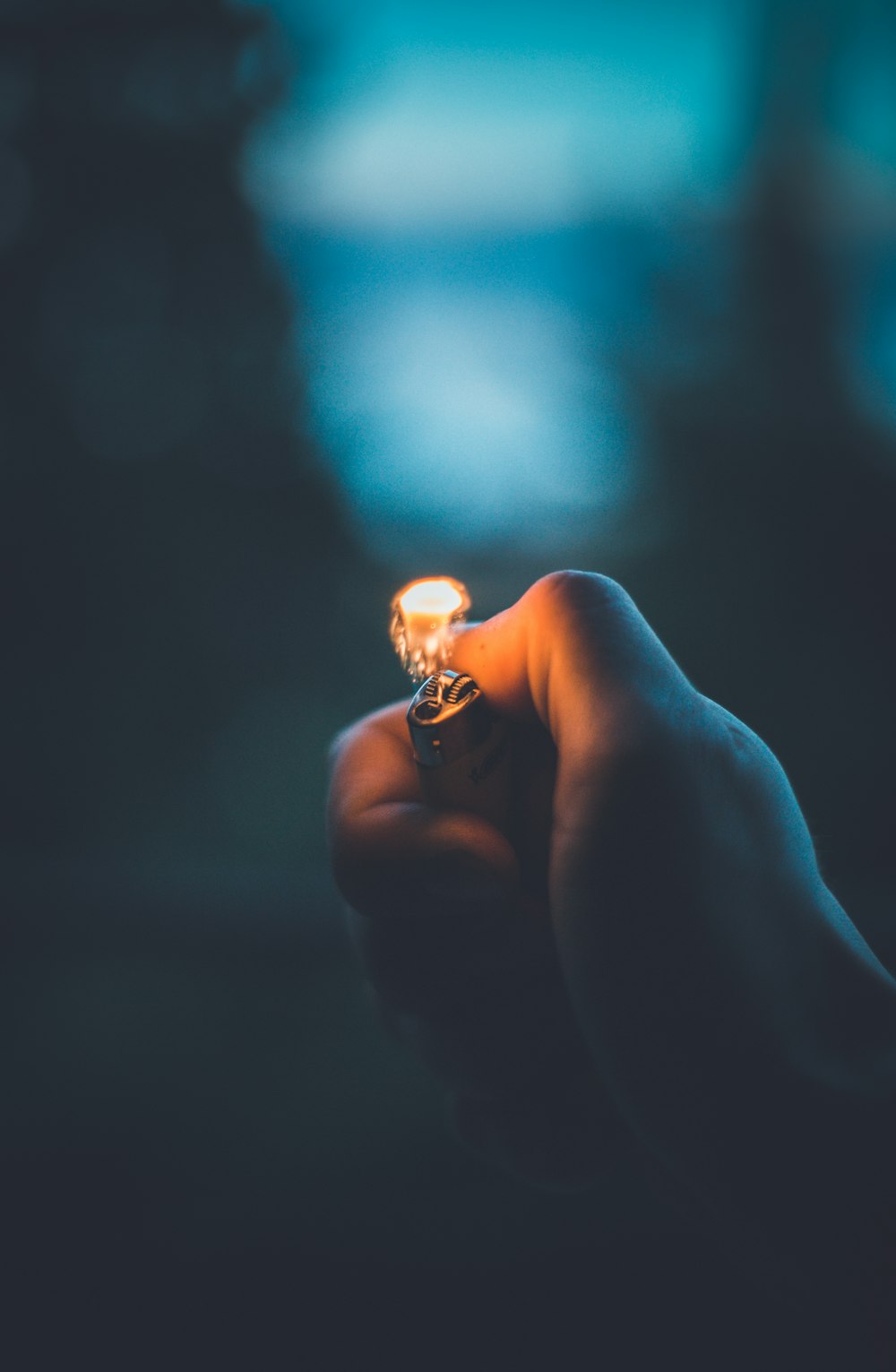 low-light photo of person holding lighter