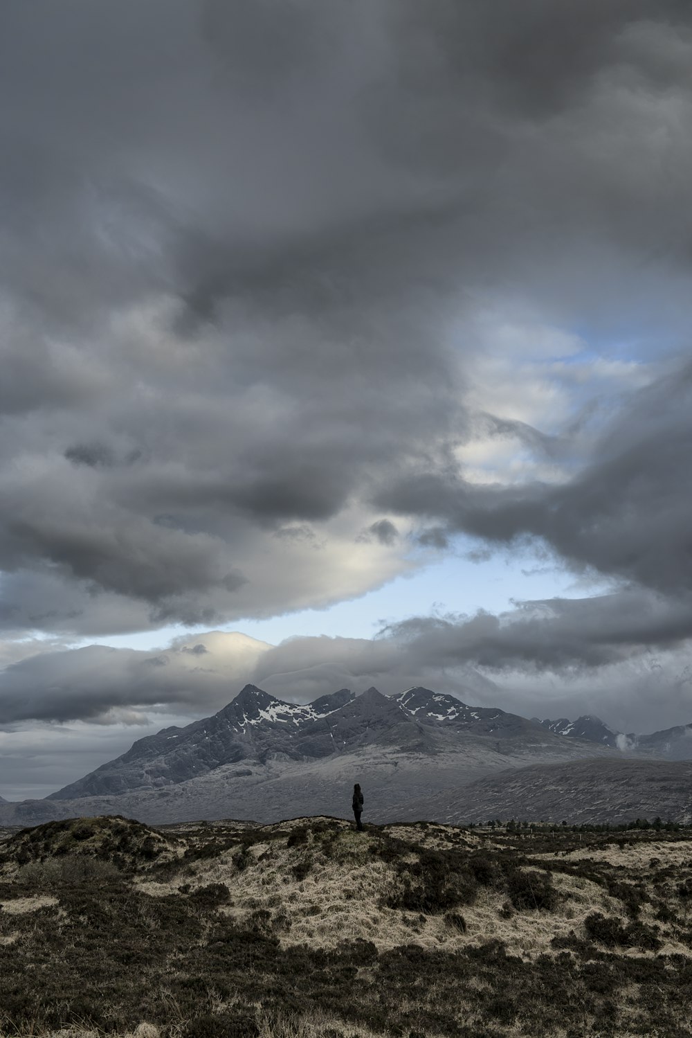 person standing on green mountain