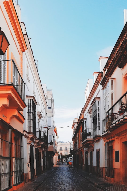alley surrounded by orange and white concrete buildings in Jerez de la Frontera Spain