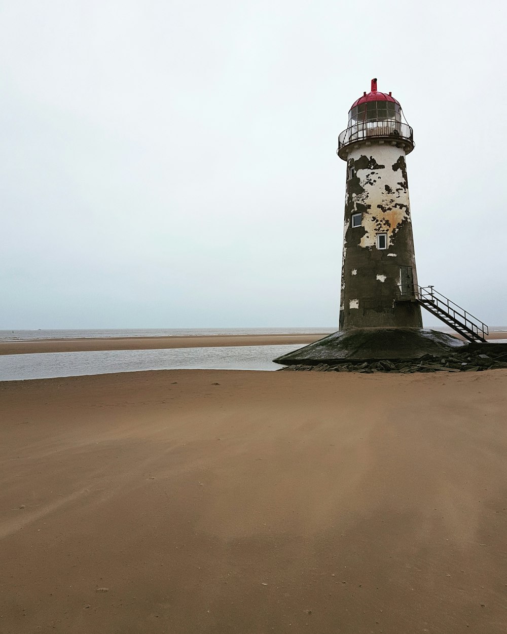 black and white lighthouse on beach