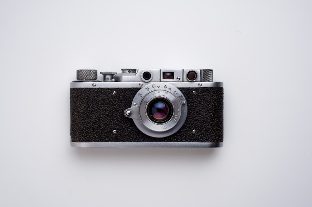 black and gray SLR camera on white background