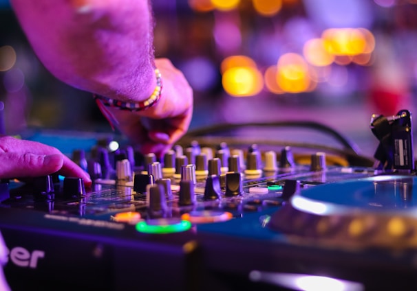 DJ controlling turntable at night