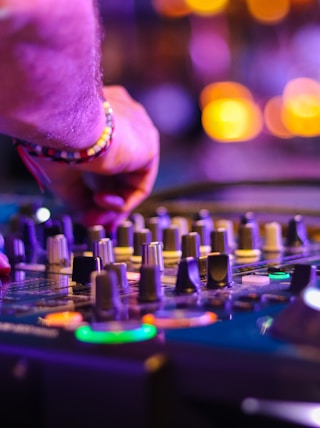 DJ controlling turntable at night