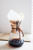 clear glass pitcher on top of brown wooden surface