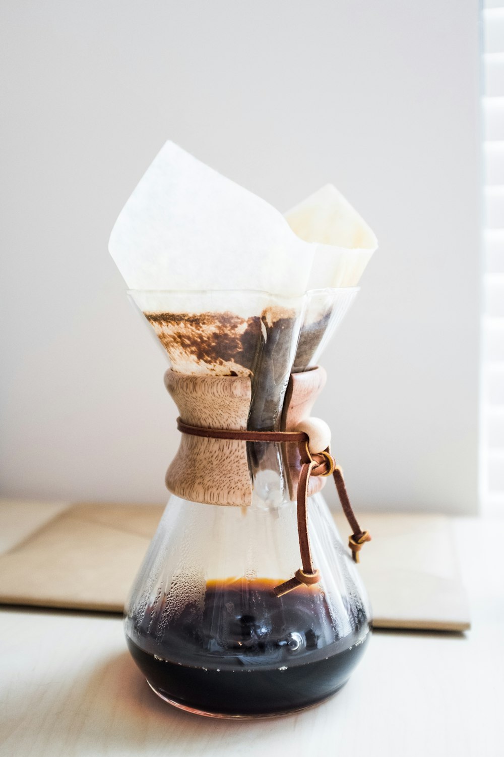 clear glass pitcher on top of brown wooden surface
