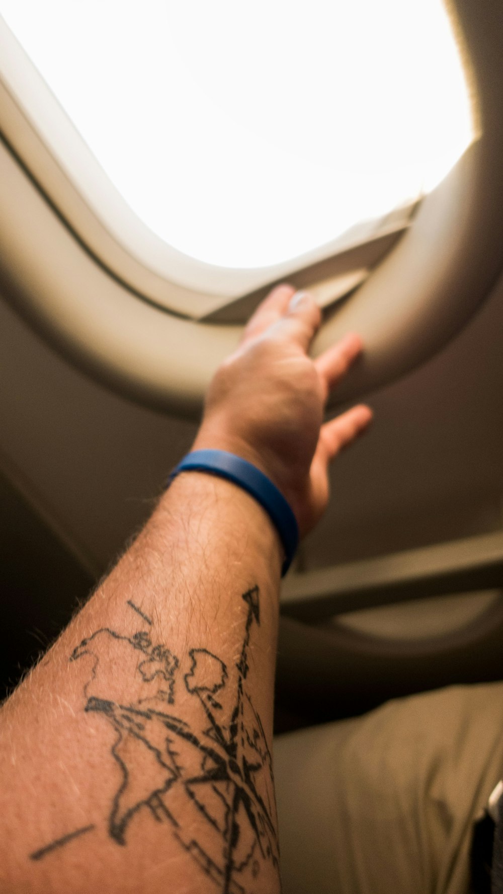 left person's arm with compass tattoo