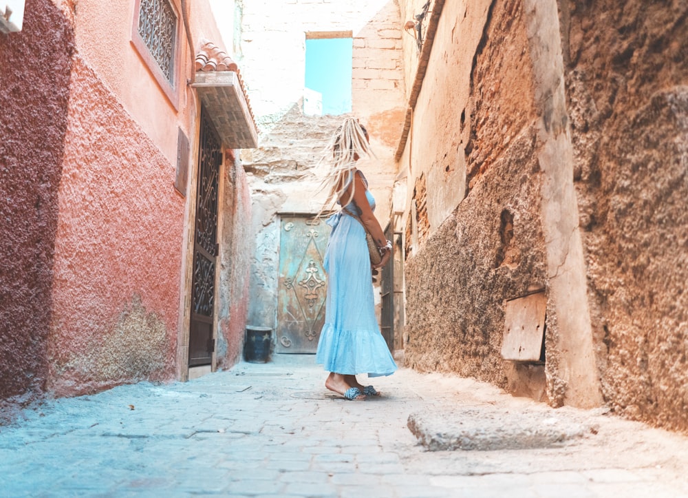 woman standing near wall during daytime