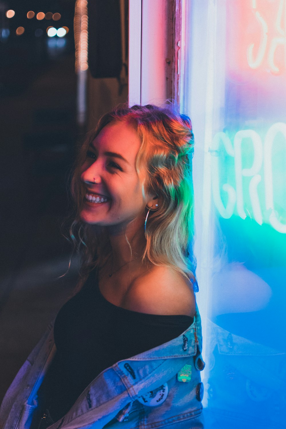 woman leaning on neon signage