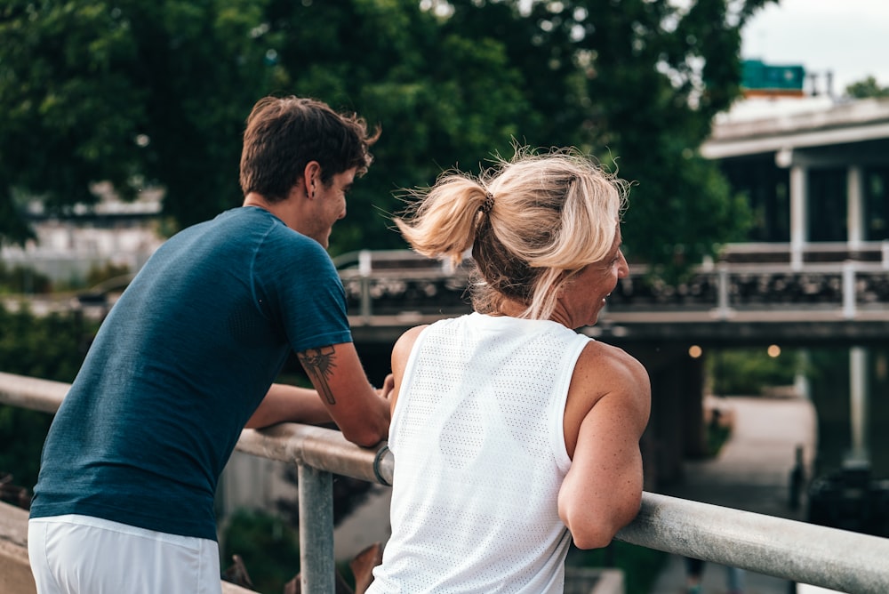 man and woman standing near the railings