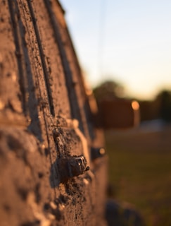 Before and after shots of a muddy tractor cleaned to shine on a sunny day.