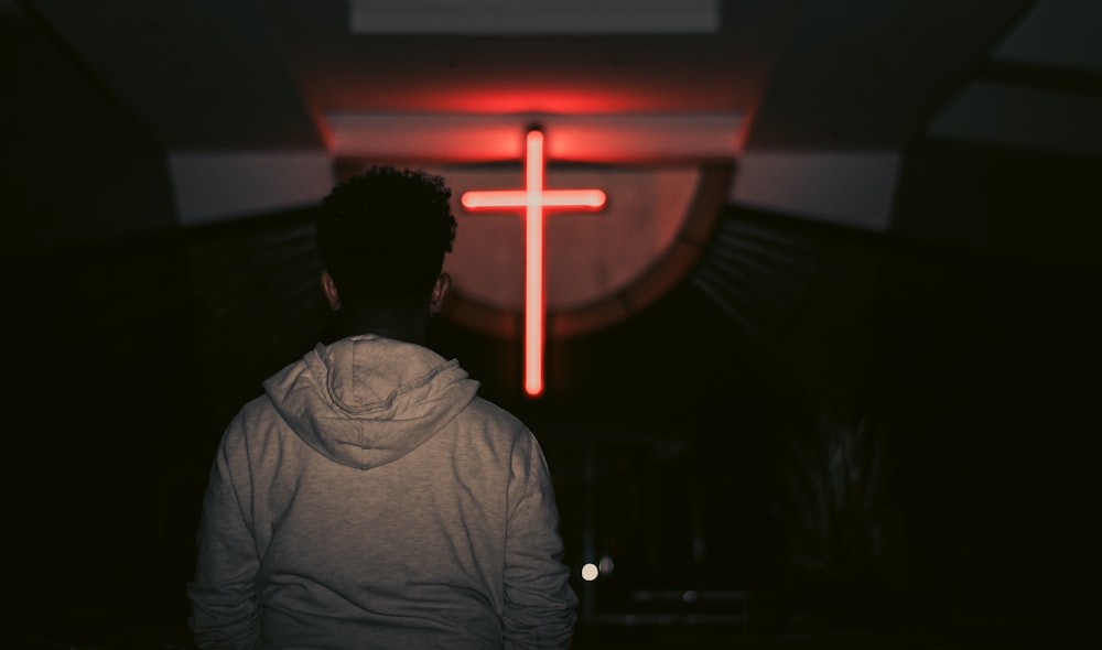man facing red LED cross
