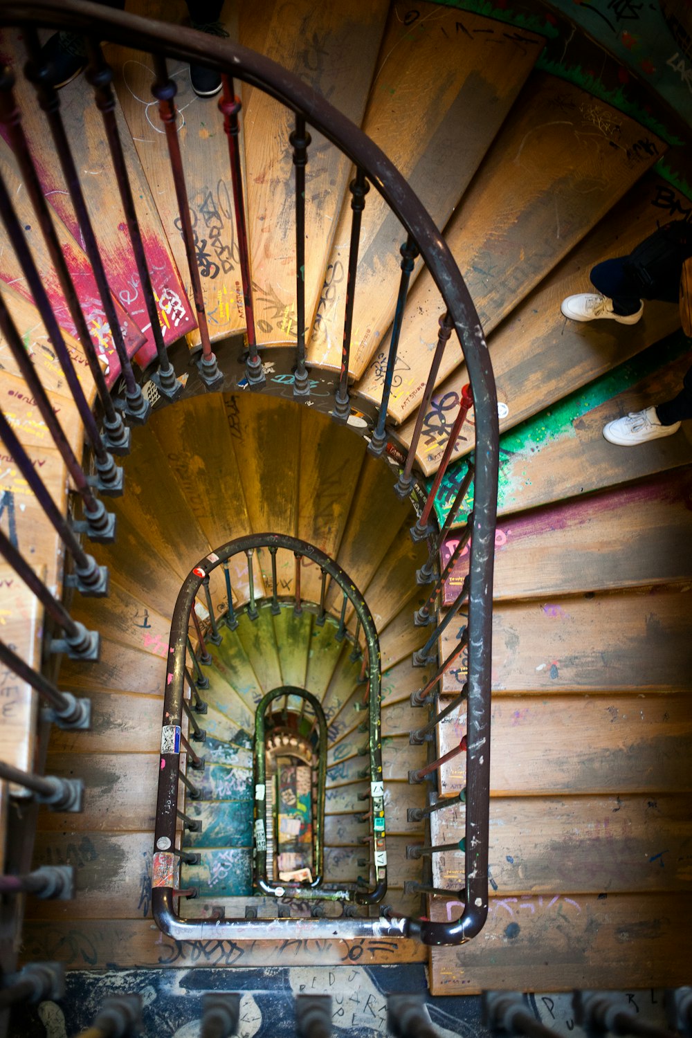 black metal framed brown wooden spiral ladder