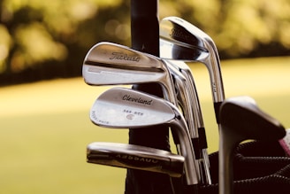 gray steel golf clubs on selective focus photo