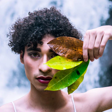 man holding three leaves