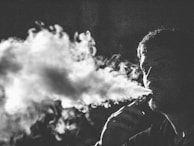 grayscale photography of smoking man