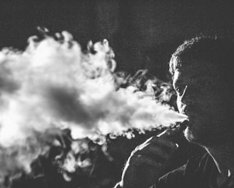 grayscale photography of smoking man