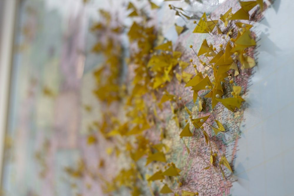 blue and multicolored map with punctured pins with paper strips