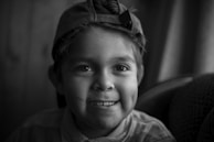 A smiling child wearing perfectly altered school uniform, captured in natural light.