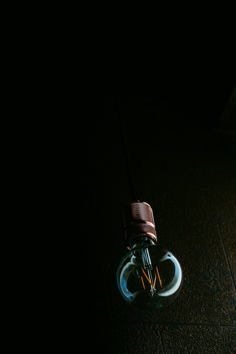 a light bulb sitting on the ground in the dark