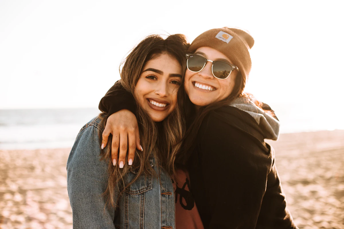 Two women hugging and smiling, happy to see each other