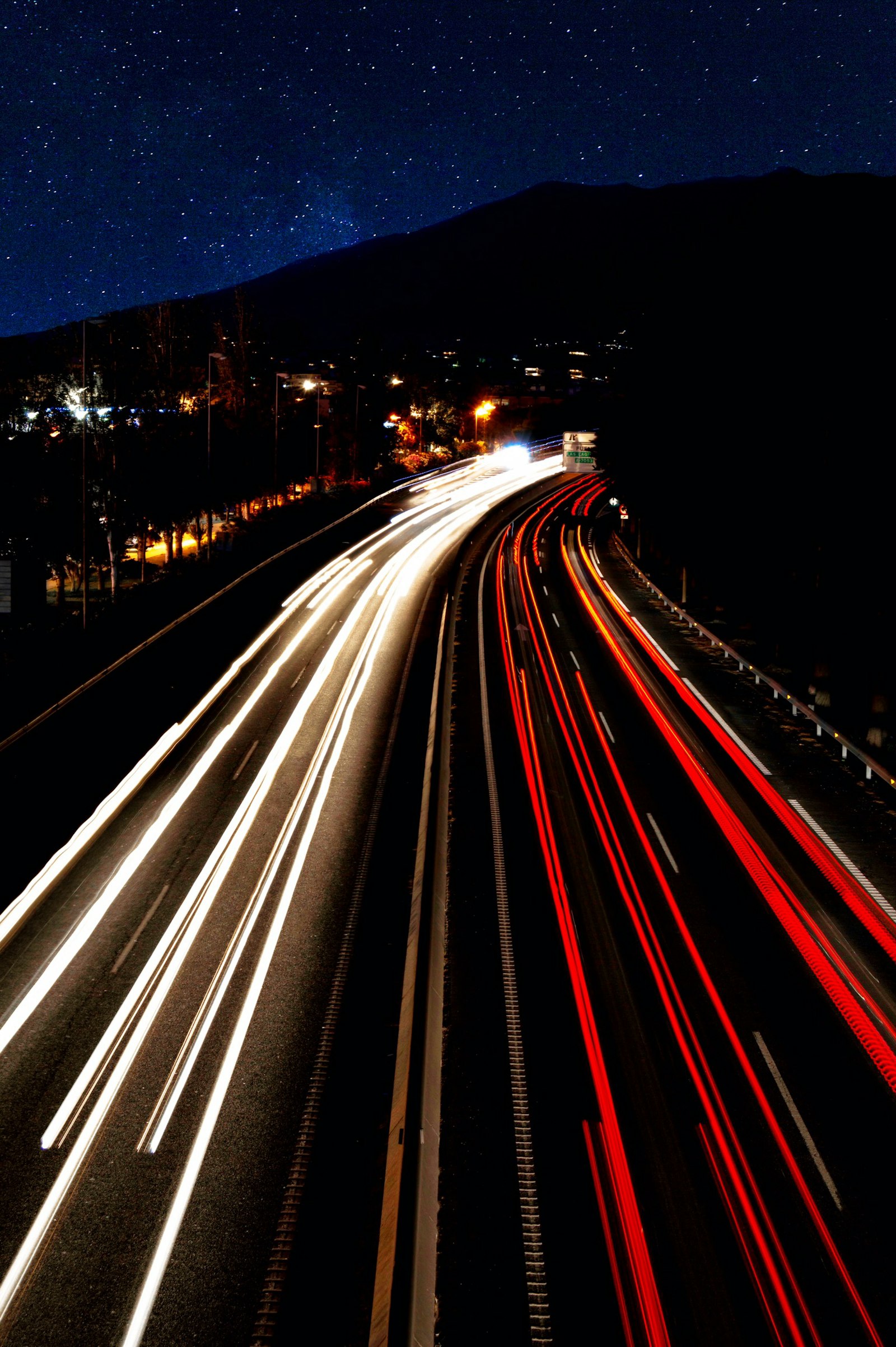 Timelapse photo of vehicles on road during nighttime