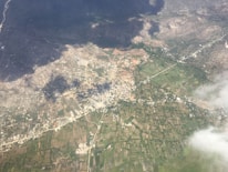 Aerial view of diverse land plots in urban and rural areas.