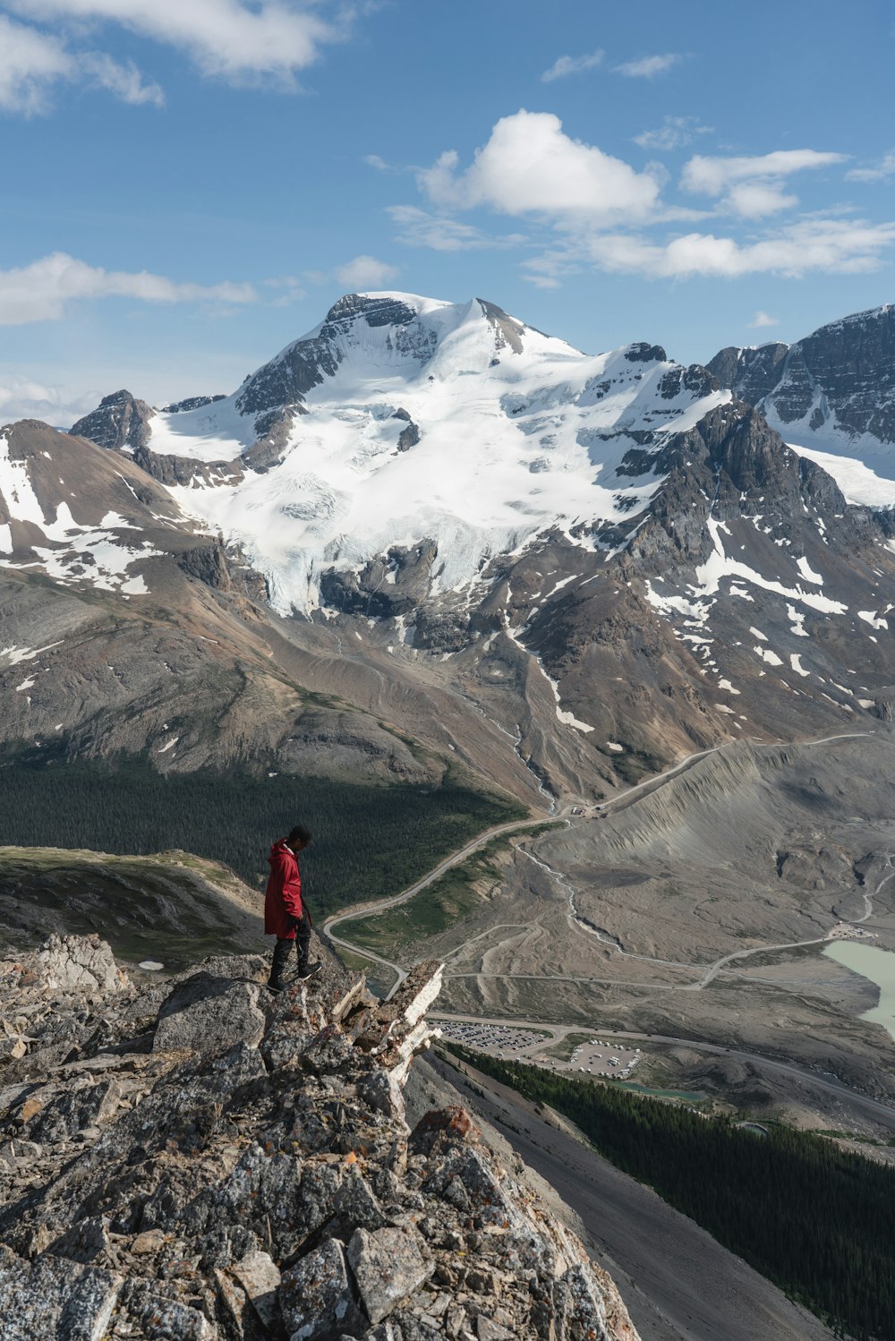 man standing on top of mountain near mountain alps