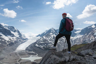 man standing on top of mountain during daytime