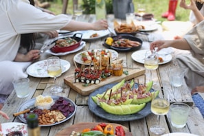 group of people eating on backyard