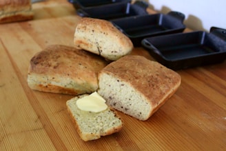 Golden honey butter cornbread skillet fresh out of the oven with melting butter on top.