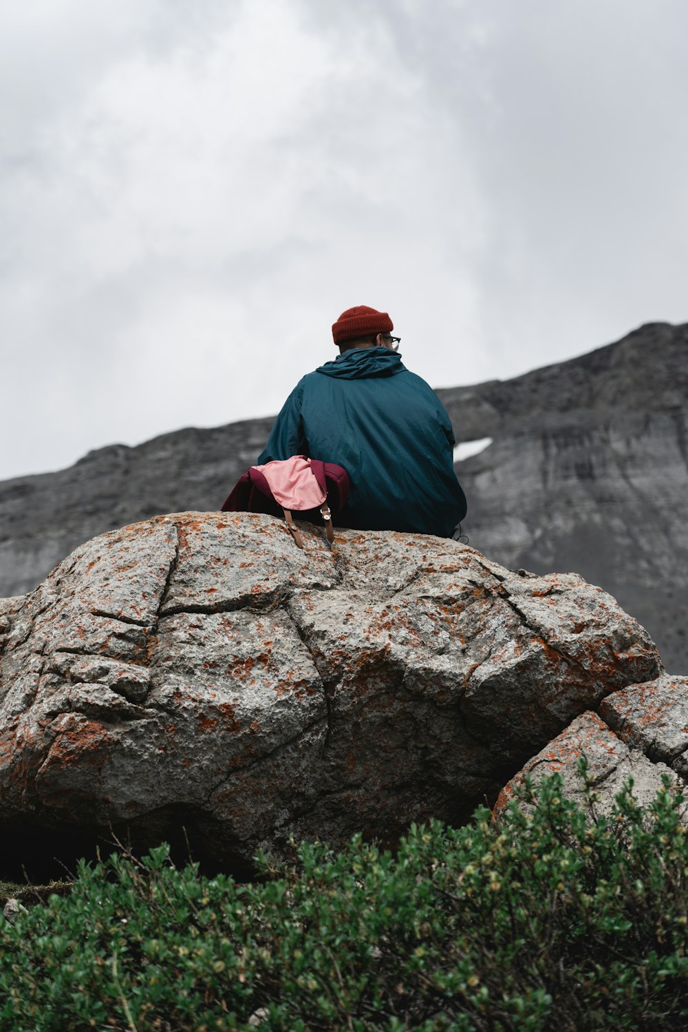 man sitting on rock