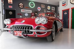 red coupe inside gray garage
