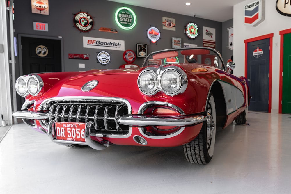 red coupe inside gray garage