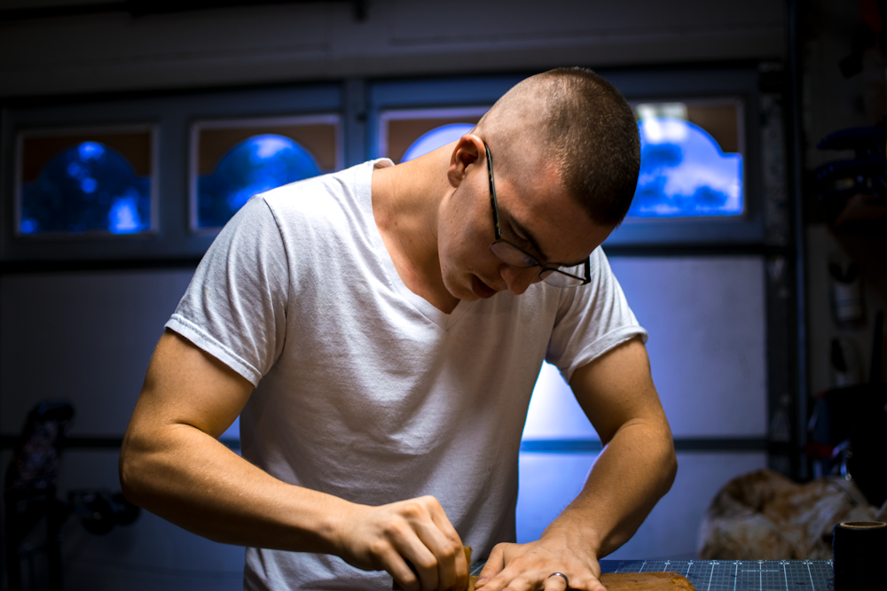 man in eyeglasses working inside room