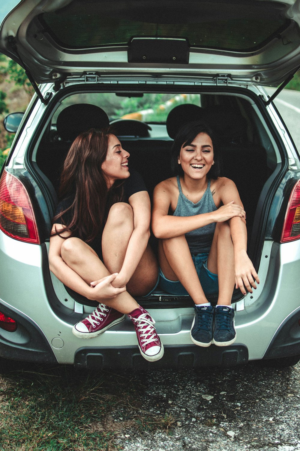 two women sitting at the back of the car