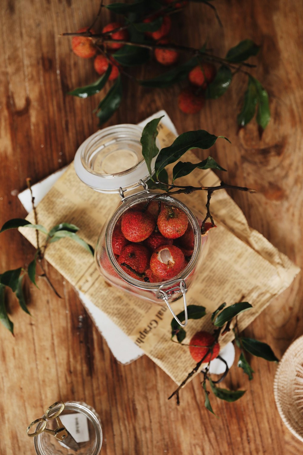 flat lay photography of jar of red fruits