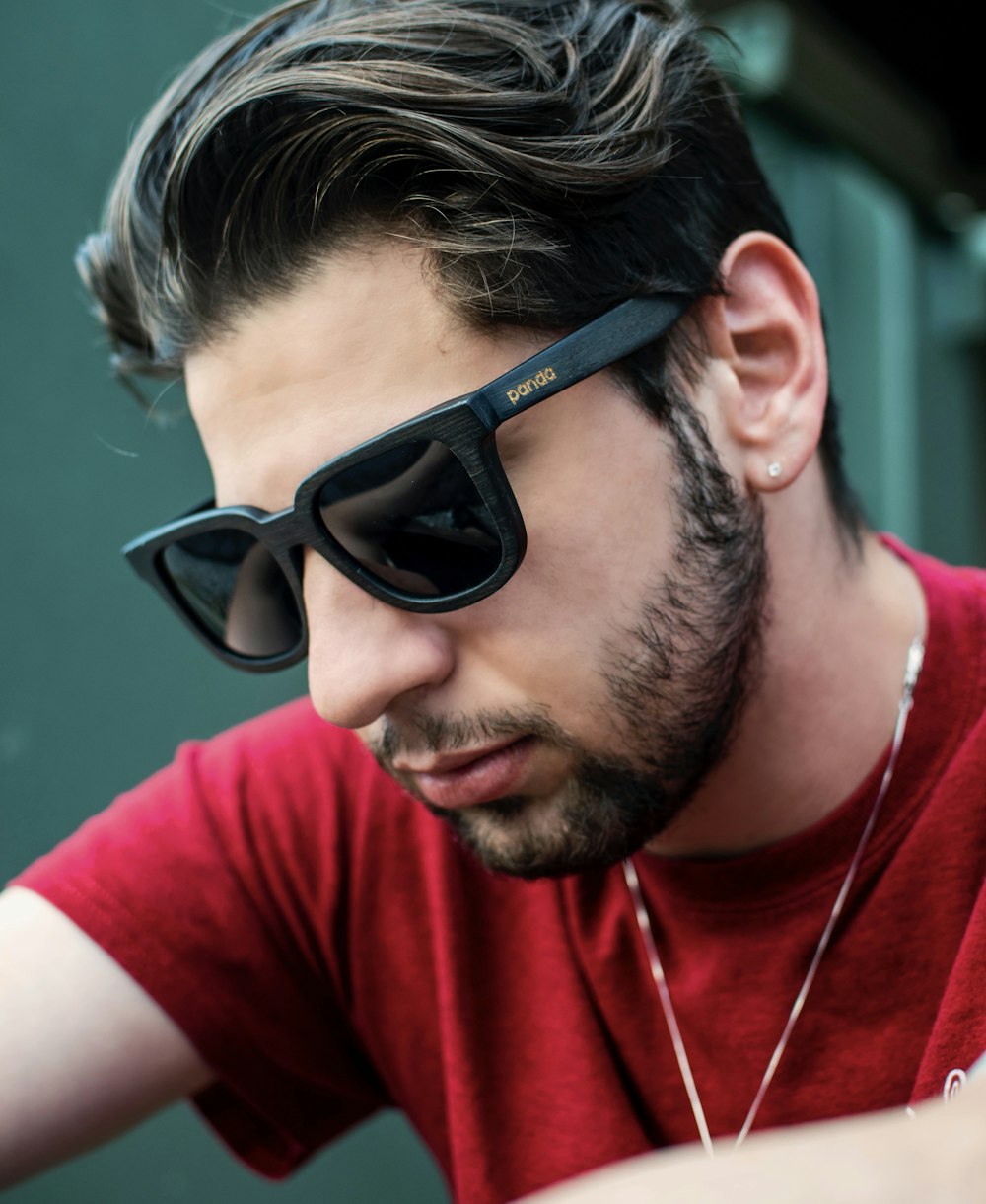 man wearing black sunglasses and red shirt