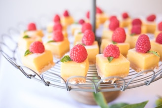 square strawberry cheesecake on round gray metal stand