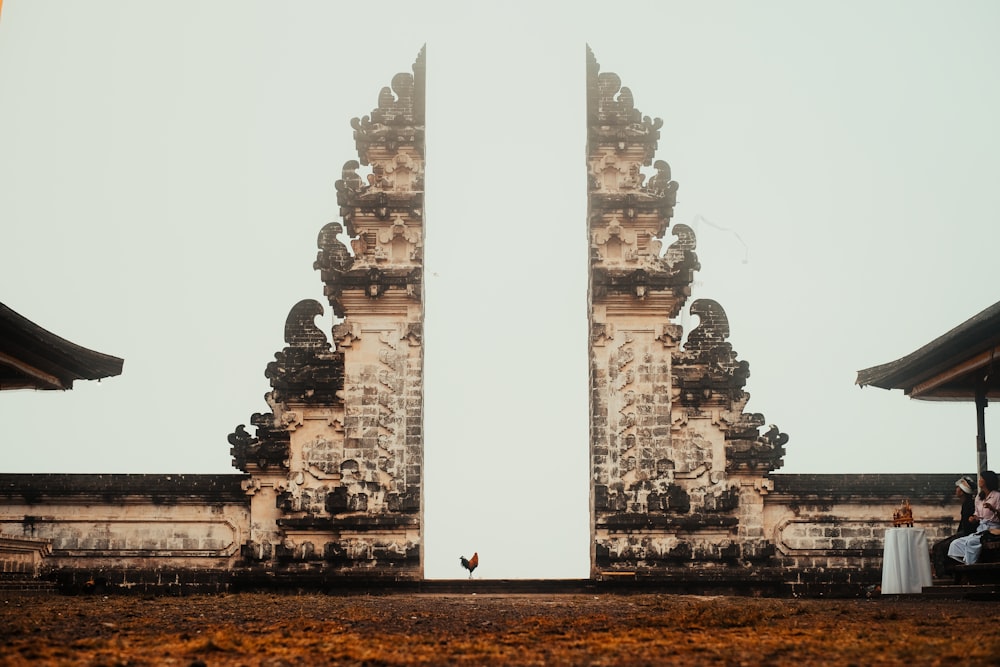 rooster in between concrete arch